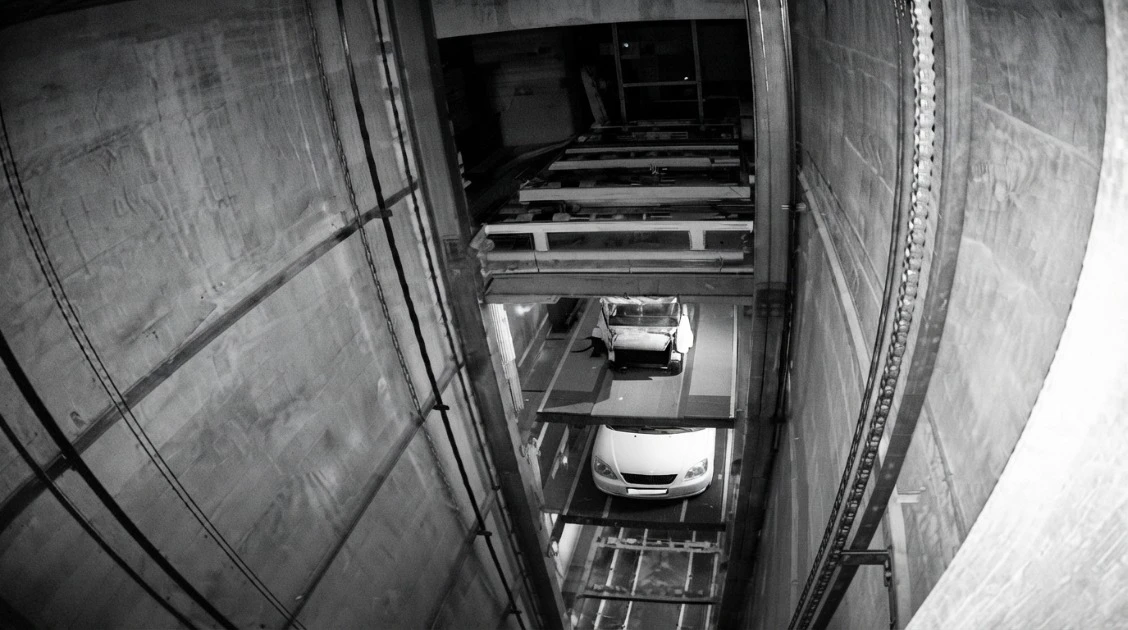 Vertical elevator shaft moving vehicles between levels